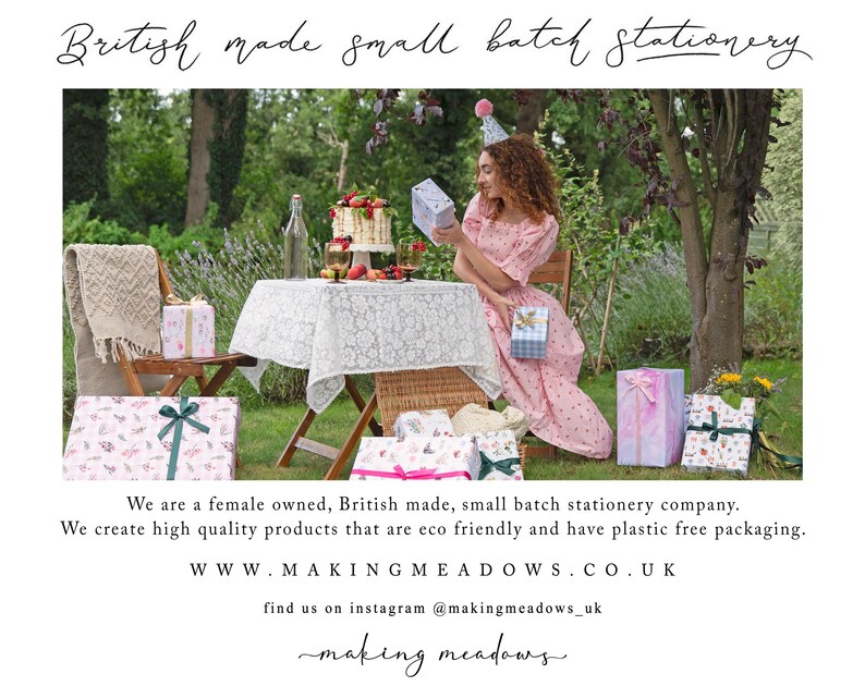 May include: An outdoor scene with a table set for a celebration, featuring gifts wrapped in patterned paper and tied with ribbons. The text "British made small batch stationery" is at the top. The scene includes a woman in a pink dress and a cake.