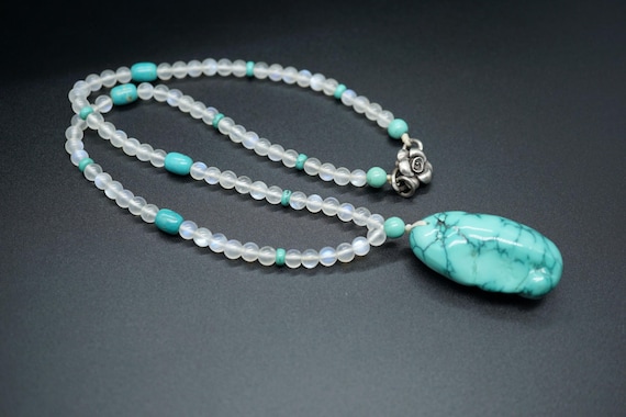 Natural Moonstone Necklace: Turquoise Charm, Silver Flower Clasp
