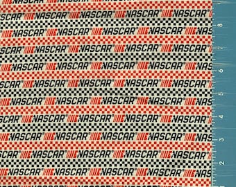 May include: White fabric with a repeating pattern of black and red checkered squares. The word "NASCAR" is printed in black letters on a red background within each square.