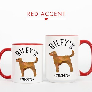 May include: Two white ceramic mugs with red accents. The mugs feature a brown dog illustration and the text "Riley's mom." The larger mug has a capacity of approximately 15 ounces, while the smaller mug is about 11 ounces.