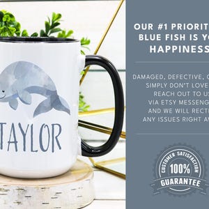 May include: White ceramic mug with a black handle. The mug features a watercolor illustration of a beluga whale and the name "TAYLOR" printed in gray. The mug is sitting on a wooden coaster. The text "OUR #1 PRIORITY AT BLUE FISH IS YOUR HAPPINESS!" is printed in black on a light blue background. The text "DAMAGED, DEFECTIVE, OR YOU SIMPLY DON'T LOVE IT? REACH OUT TO US VIA ETSY MESSENGER AND WE WILL RECTIFY ANY ISSUES RIGHT AWAY." is printed in black on a light blue background. A circular sticker with the text "CUSTOMER SATISFACTION 100% GUARANTEE" is printed in black on a white background.