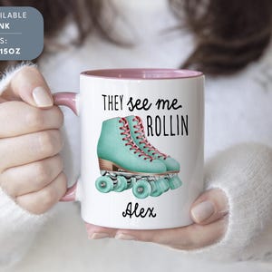 a woman holding a coffee mug with roller skates on it