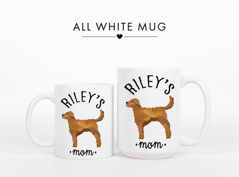May include: Two white ceramic mugs with a brown dog illustration. The mugs have the text "Riley's mom" and "ALL WHITE MUG". The dog illustration is in a watercolor style.