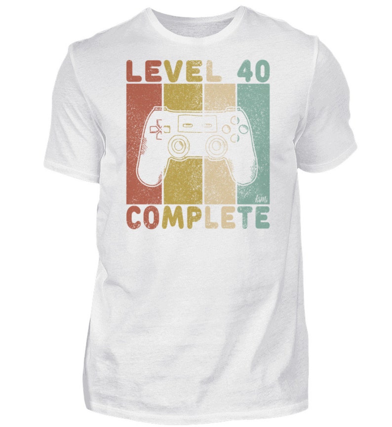 May include: White t-shirt with a retro-style graphic of a video game controller and the text "LEVEL 40 COMPLETE".