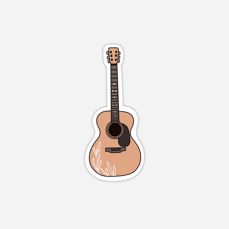 Pode incluir: Um adesivo de uma guitarra ac&uacute;stica com um corpo marrom claro e um design floral branco. A guitarra tem um protetor de palheta preto e um pesco&ccedil;o marrom.