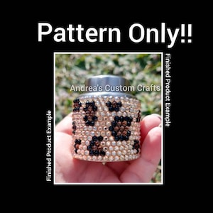 May include: A silver bottle with a leopard print design made with rhinestones. The bottle is being held in a hand. The text "Andrea's Custom Crafts" is visible on the bottle.