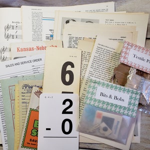 May include: A collection of vintage ephemera, including a sheet of music, a sales and service order form, a math flashcard, a piece of fabric, and a small bag labeled "Bits & Bobs".