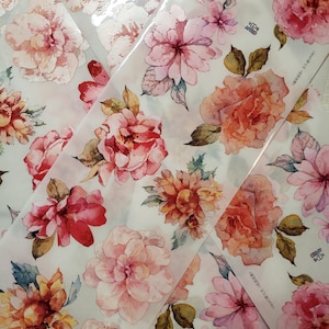 May include: A sheet of clear, translucent paper with a repeating pattern of watercolor flowers in shades of pink, red, and orange. The flowers are arranged in a random pattern and have a slightly blurred effect. The paper is labeled "Great Value" and "Made in China".