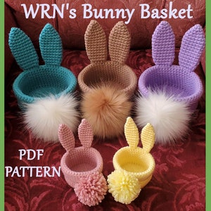May include: A set of four crocheted bunny baskets in teal, brown, purple, and pink. Each basket has a fluffy tail and is ideal for holding small items.