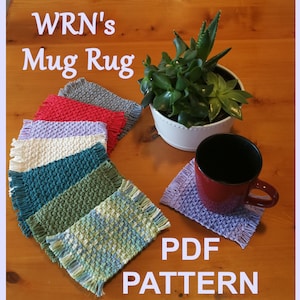 May include: A set of colourful crocheted mug rugs with fringe edges. The rugs are arranged in a semi-circle on a wooden surface. The text "WRN's Mug Rug PDF PATTERN" is visible in the image.
