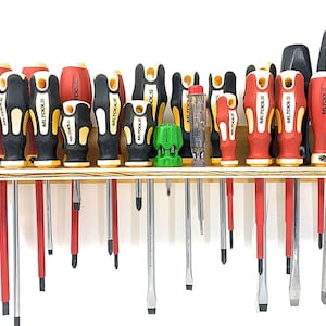 May include: A collection of screwdrivers with red, black, and yellow handles, arranged on a wooden shelf. The handles have the "MLTOOLS" logo. Various sizes and types of screwdrivers are displayed, including flathead and Phillips head.