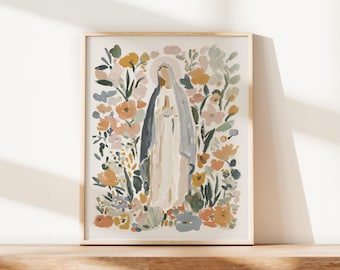 May include: Framed art print featuring a watercolor illustration of a religious figure surrounded by colorful flowers. The figure is depicted in a long white robe and a blue veil, with a halo. The floral arrangement includes peach, yellow, and green tones.