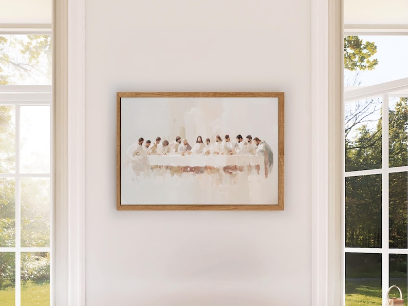May include: A framed painting depicting a scene of the Last Supper. The painting is done in a watercolor style with muted colors and a soft, ethereal feel. The figures are dressed in white robes and are seated around a table. The painting is set against a white background.