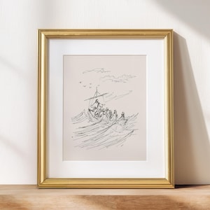 May include: Framed black and white illustration of a boat with several figures on rough seas. The artwork is in a gold frame and rests on a wooden surface. The image depicts a religious theme.
