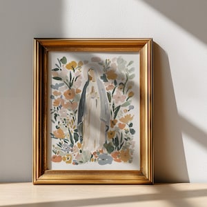 May include: A framed watercolor print featuring a figure in a white robe and veil, surrounded by colorful flowers in shades of yellow, orange, and pink. The artwork is set in a gold-colored frame, creating a classic and elegant aesthetic.