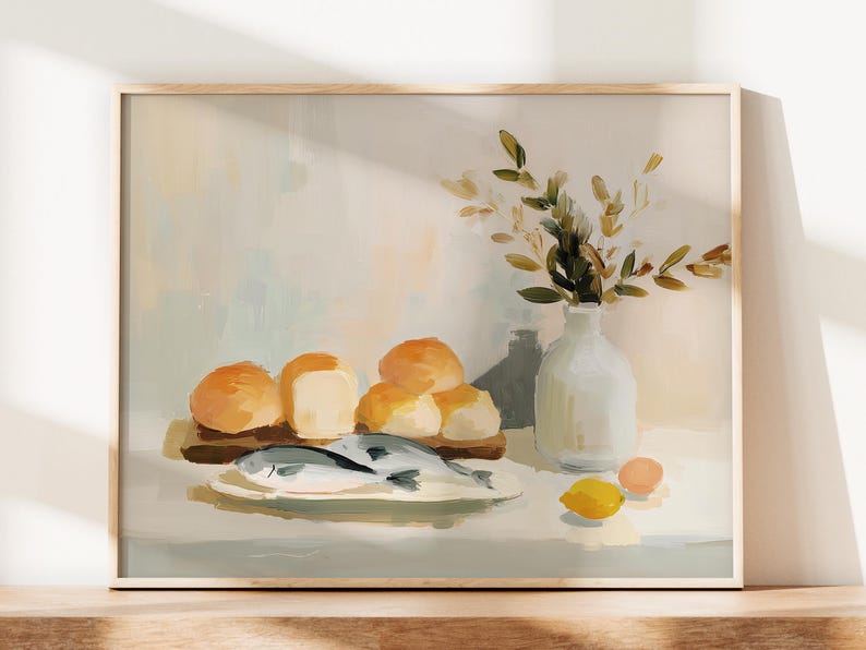 May include: A framed still life painting featuring a wooden cutting board with rolls, a plate with fish, a white vase with greenery, and a lemon. The color palette includes beige, yellow, and white.