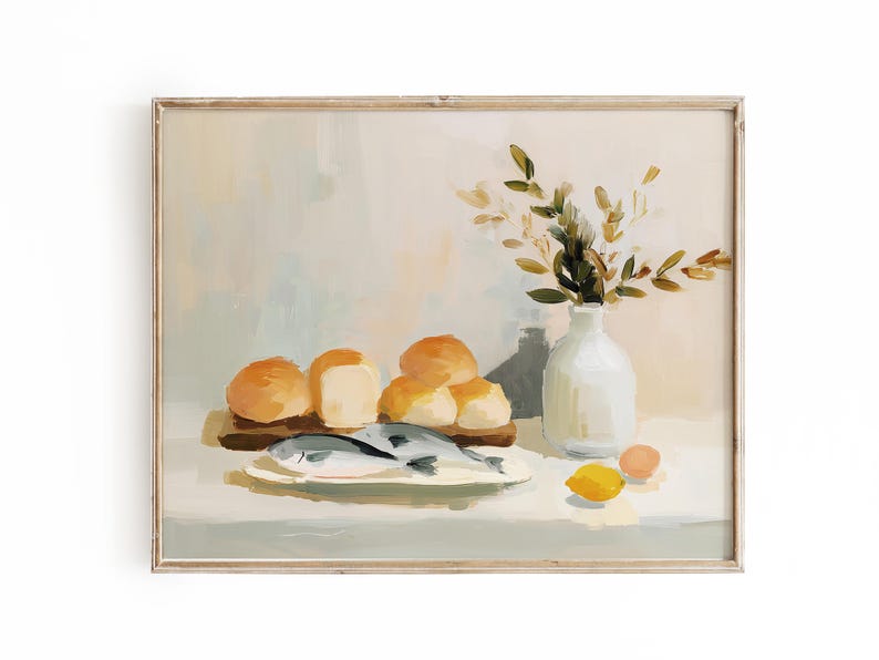 May include: A framed still life painting featuring a rustic arrangement. It depicts a wooden board with rolls and a plate with fish. A white vase holds greenery, and a lemon and egg are also present. The color palette is soft and warm.