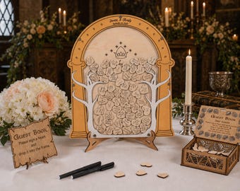 May include: An arched wooden guest book frame with a crown and star design, filled with small wooden hearts. Includes a matching wooden box for hearts, two black pens, and a sign that reads: Guest Book, Please sign a heart and drop it into the frame.