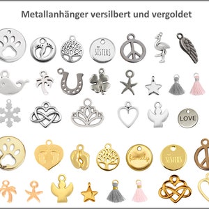 May include: A collection of silver and gold metal charms featuring various designs, including paw prints, a tree, a peace sign, a flamingo, a horseshoe, a clover, a star, a snowflake, a heart, a dove, a palm tree, a starfish, a tassel, and the word "LOVE".