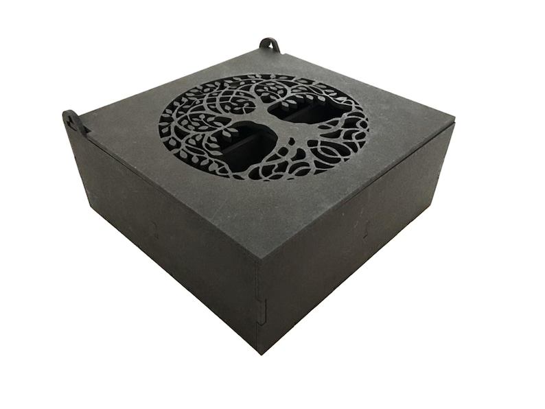 May include: A black wooden box with a tree of life design cut out of the top. The box has a hinged lid and is made of a sturdy material.