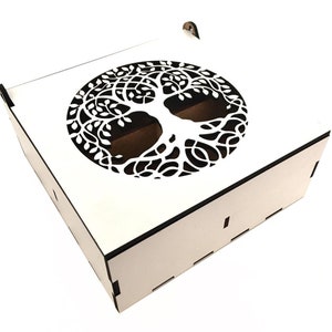 May include: White wooden box with a cutout of a tree of life design on the lid. The box has a hinged lid and a small handle.