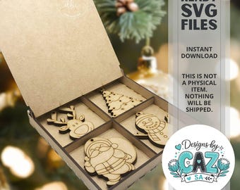 May include: A light brown wooden box with an open lid containing four laser-cut wooden Christmas ornaments shaped like a reindeer, a Christmas tree, a snowman, and Santa Claus. Text on the right reads LASER READY SVG FILES INSTANT DOWNLOAD.