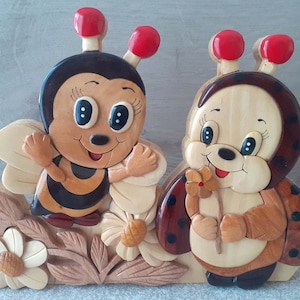 beautiful decoration in different types of varnished wood of the ladybug and the wasp