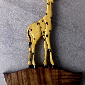 personalized wooden giraffe door sign with first name offered for the child&#39;s room