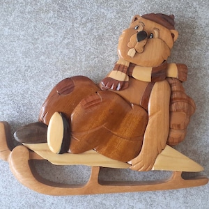 figurine of the marmot in varnished wood on his sleigh