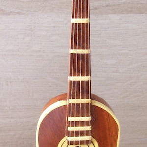 wooden model of the classical guitar on its base