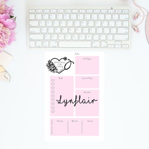 May include: A pink printable daily planner with a black floral heart design and the text "Believe there is the magic in the making". The planner includes sections for goals, to-do list, tasks, notes, and a mood tracker.