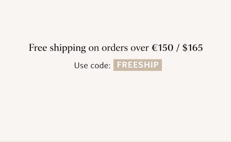 May include: Text on a light beige background reads "Free shipping on orders over $165". Below, it says "Use code: FREESHIP" in a rectangular box. The text is in a simple, clean font.