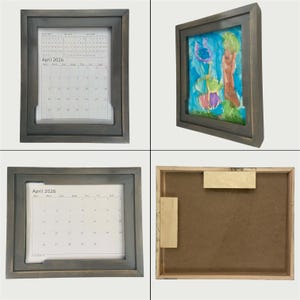 May include: A set of four images showcasing a gray wooden frame. The frame holds a calendar for April 2026 and a colorful painting. The frame has a recessed area for the calendar and artwork. The back of the frame is also visible.