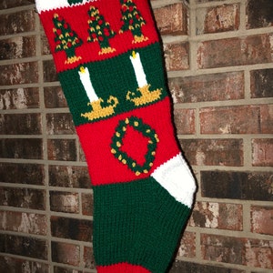 May include: Red, green and white knitted Christmas stocking with the name "LEE" and a wreath design.