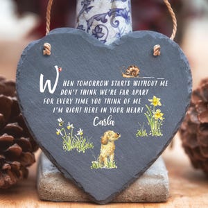May include: A black heart-shaped slate plaque with a white inscription that reads "When tomorrow starts without me don't think we're far apart for every time you think of me I'm right here in your heart Carla". The plaque features a small snail, a bee, and a yellow dog with a flower background.