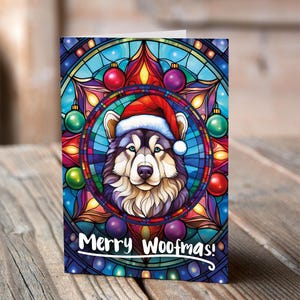 Carte de Noël Malamute d'Alaska dans un bonnet de Noel