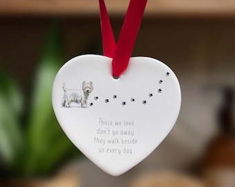 May include: White ceramic heart ornament featuring a white dog illustration and the text "Those we love don't go away, they walk beside us every day".
