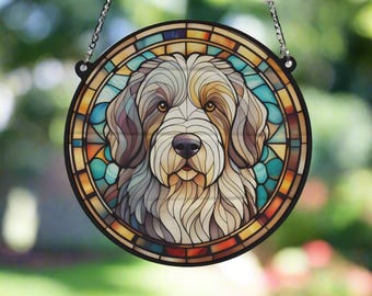 May include: A stained glass window hanging with a colorful design of a white and brown dog with a blue background.