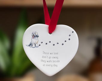 May include: White ceramic heart ornament with a black and white illustration of a dog and the text "Those we love don't go away, they walk beside us every day".