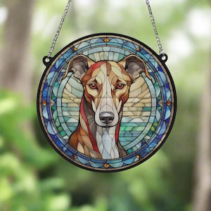 May include: A stained glass window hanging with a colourful image of a dog's head. The dog has brown, white and black fur. The background is a blue and green stained glass design.