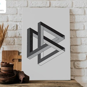 May include: A framed print featuring a black and gray impossible triangle optical illusion. The artwork has a textured, speckled appearance and is set against a light gray background. The Design Papery logo is in the upper left corner.