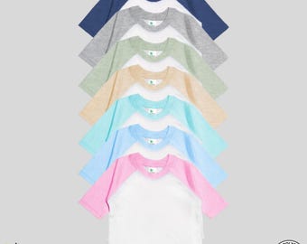 May include: A stack of ten blank, short-sleeved, baseball t-shirts in various colors, including white, pink, light blue, turquoise, beige, light green, gray, and navy blue. The shirts are made of 65% polyester and 35% cotton.