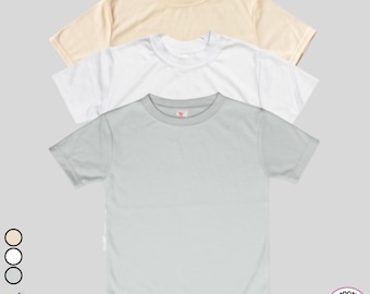 May include: Three short-sleeved t-shirts in cream, white, and light gray are stacked on a light gray background. The shirts have a crew neck and a small logo on the upper chest. The bottom right corner has a 100% polyester label.