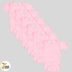 May include: Six pink baby onesies with short sleeves. The onesies are made of a soft, comfortable material and are perfect for everyday wear.