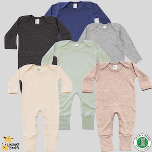 May include: Six long-sleeved baby onesies in different colors: charcoal gray, light blue, light gray, light green, beige, and light pink. The onesies have a round neckline and snap closures at the bottom. The fabric is a blend of 65% polyester and 35% cotton.