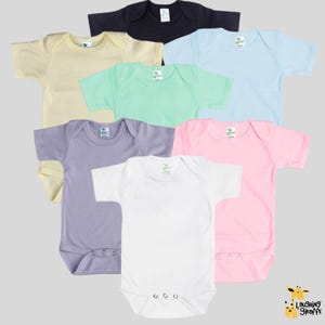 May include: Set of ten baby onesies in various colors, including white, black, pink, light blue, yellow, green, and gray. The onesies have short sleeves and snap closures.
