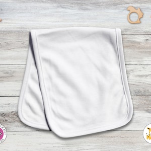 May include: A white baby receiving blanket made of 100% interlock knit polyester. The blanket is rectangular with rounded corners. The Laughing Giraffe logo is in the bottom right corner. Wooden baby toys are in the background.