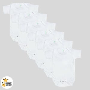 May include: Six white short-sleeved baby onesies with snap closures. The onesies are arranged in a stack, with the top onesie folded in half.