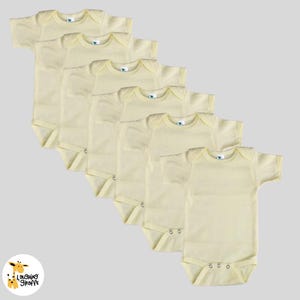 May include: A set of six yellow baby onesies with short sleeves. The onesies are made of a soft, comfortable fabric and are perfect for everyday wear.