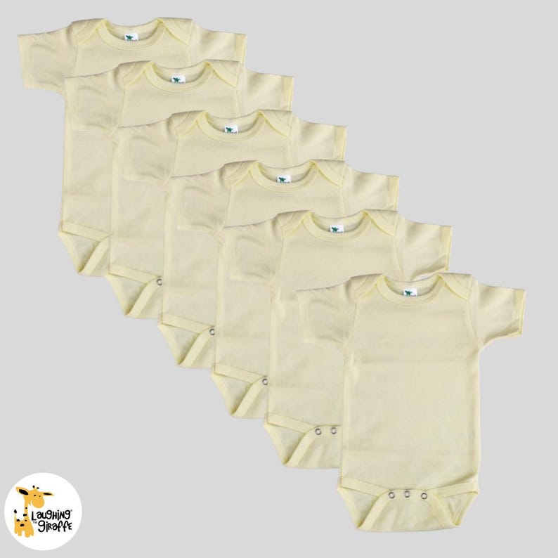 May include: A set of six yellow baby onesies with short sleeves. The onesies are made of a soft, comfortable fabric and are perfect for everyday wear.